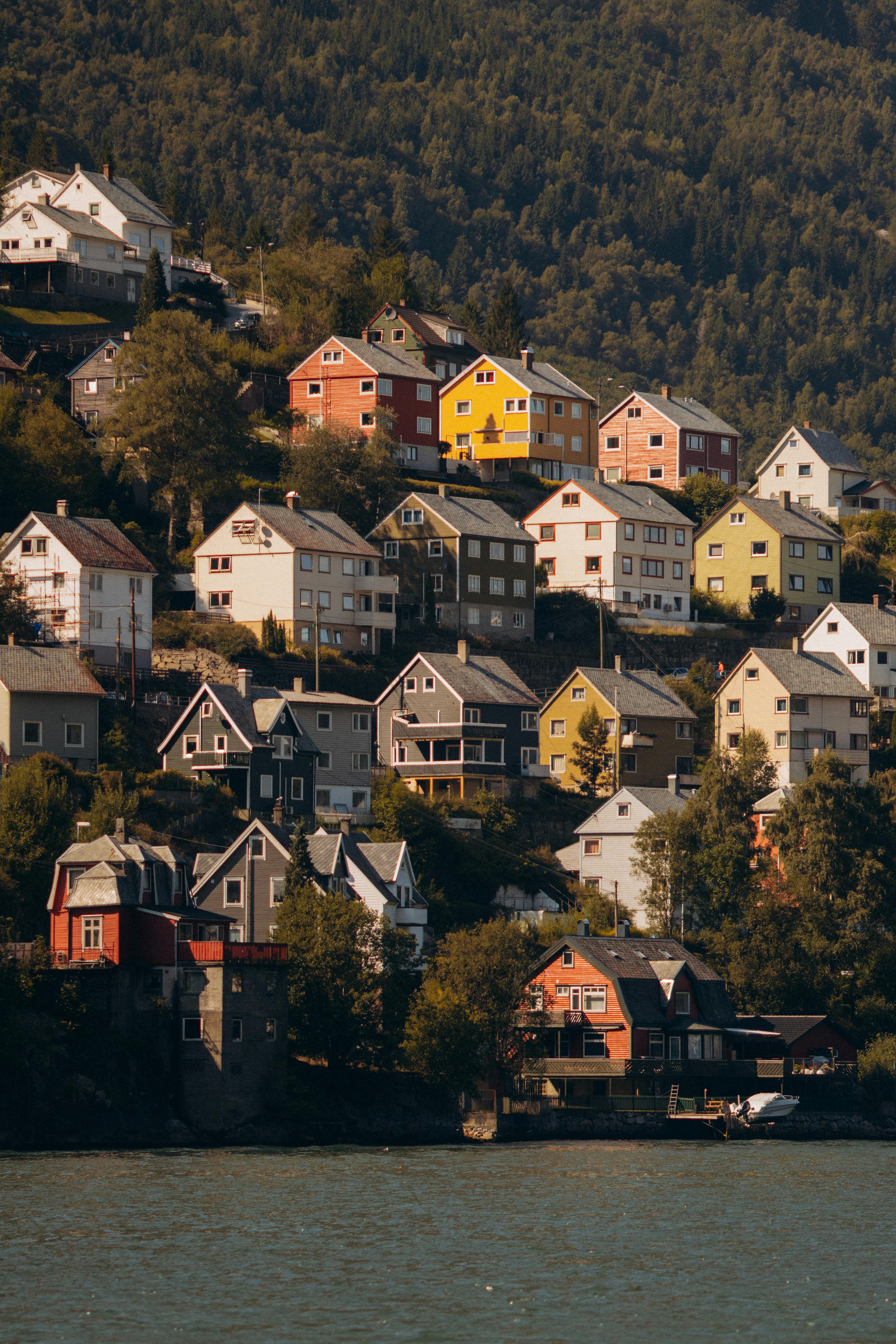 Colorful houses on a hillside by the water in Bergen, Norway, showcasing vibrant architecture