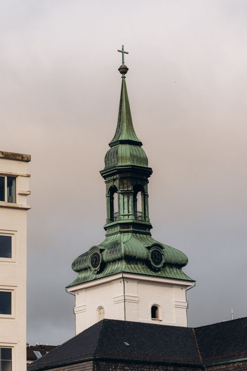 Free Captivating view of a historic church steeple in Bergen, showcasing architectural details. Stock Photo
