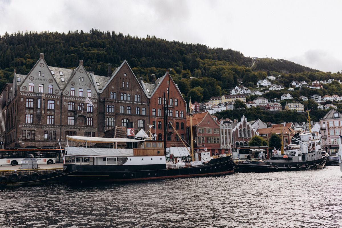 Bryggen wharf with boats in Bergen harbour on a cloudy day