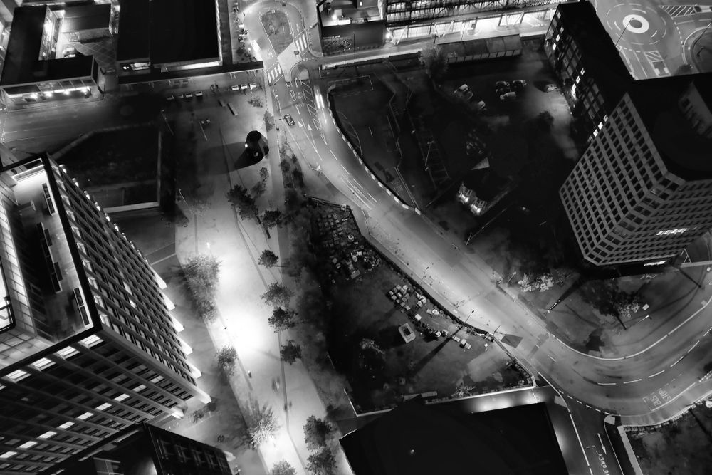 Black and white aerial view of Coventry city at night showcasing urban landscape and architecture.