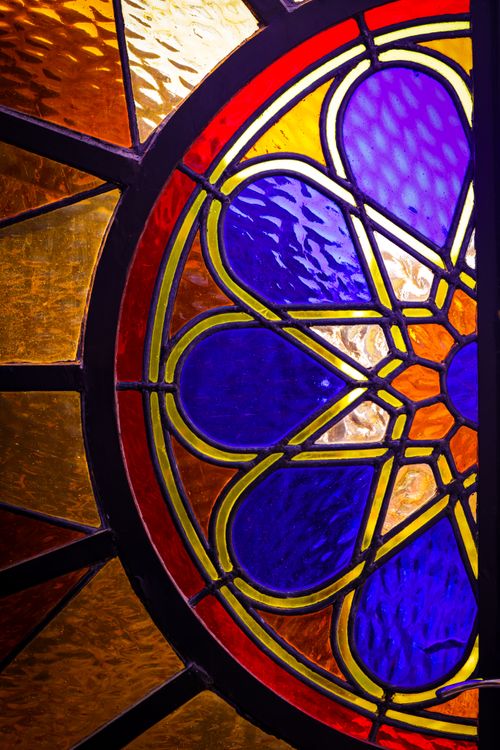 Free Intricate stained glass window with bold colors and geometric patterns. Stock Photo