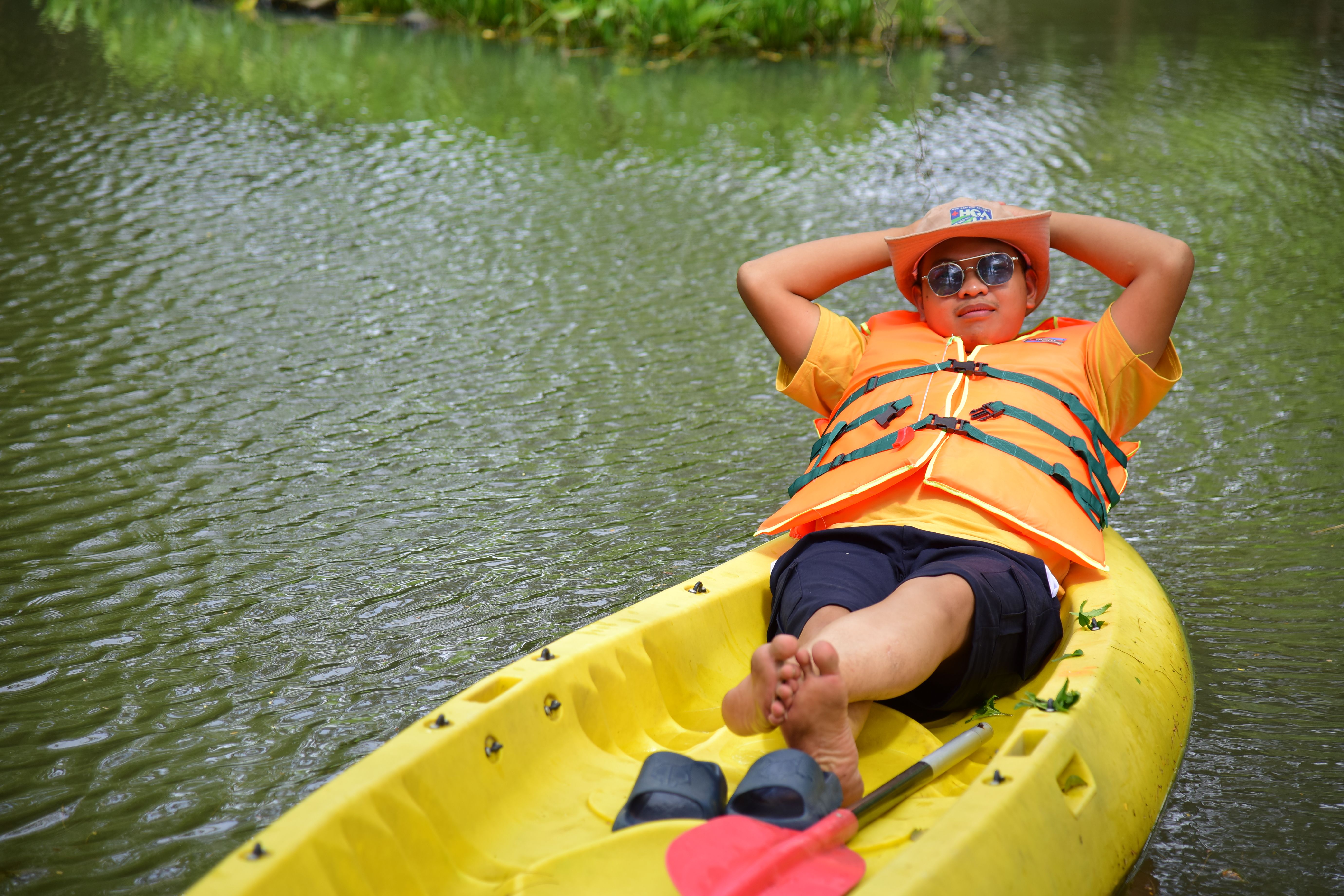 Relaxing in a Yellow Kayak on a Serene Lake · Free Stock Photo