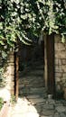 Open Stone Archway in Sunlit Garden Pathway