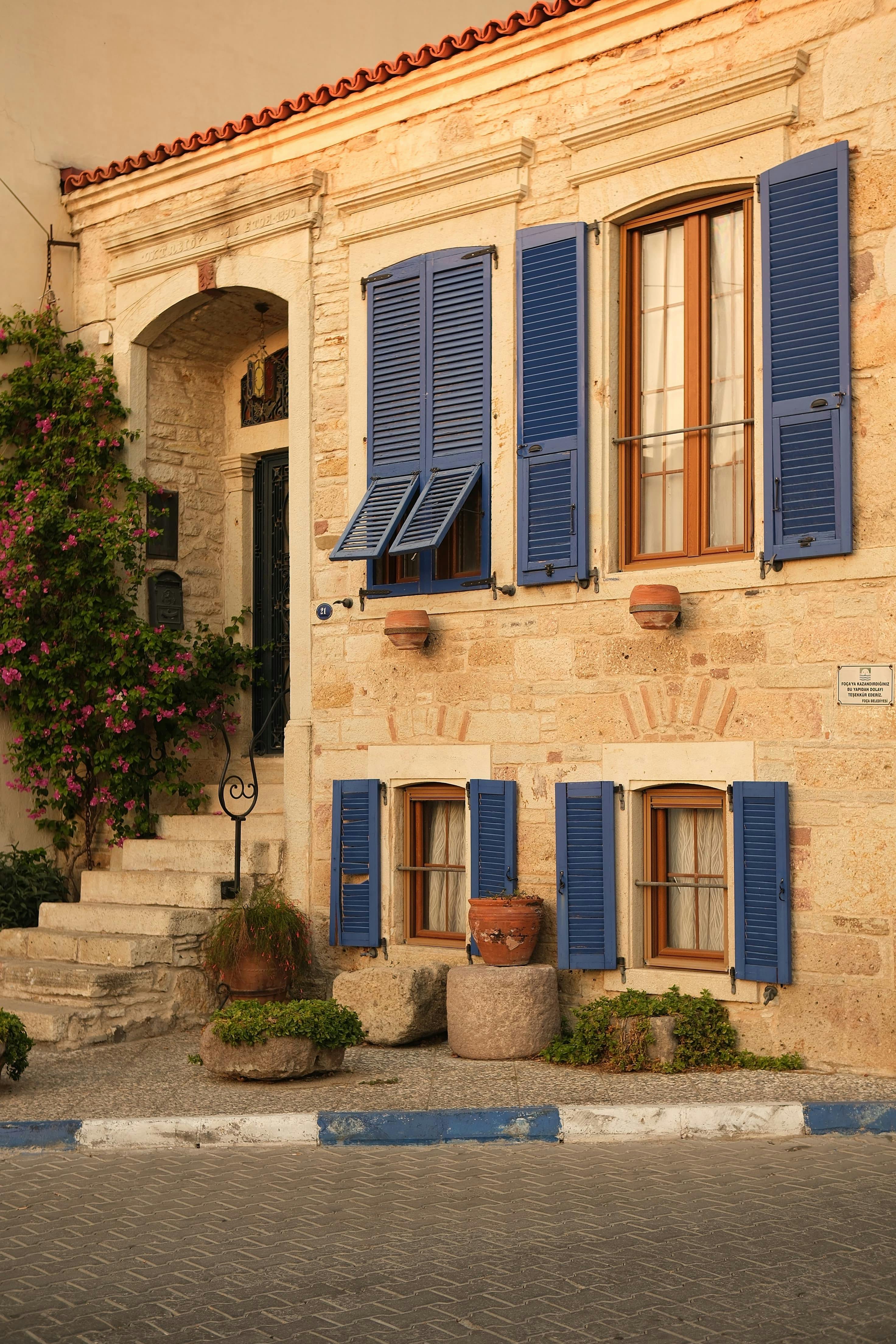 A Beige Building with Blue Window Shutters · Free Stock Photo, image size:2944x4416