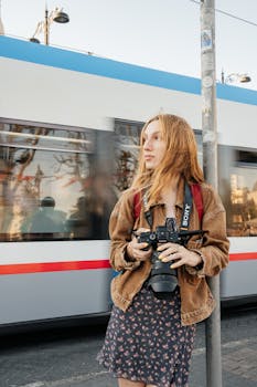 Young photographer in Istanbul capturing city life with motion blur tram in the background.