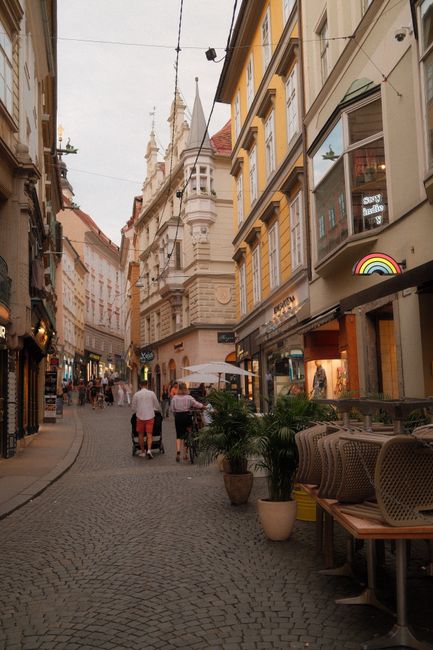 Explore the beauty of an Austrian city street filled with historic architecture and vibrant life.