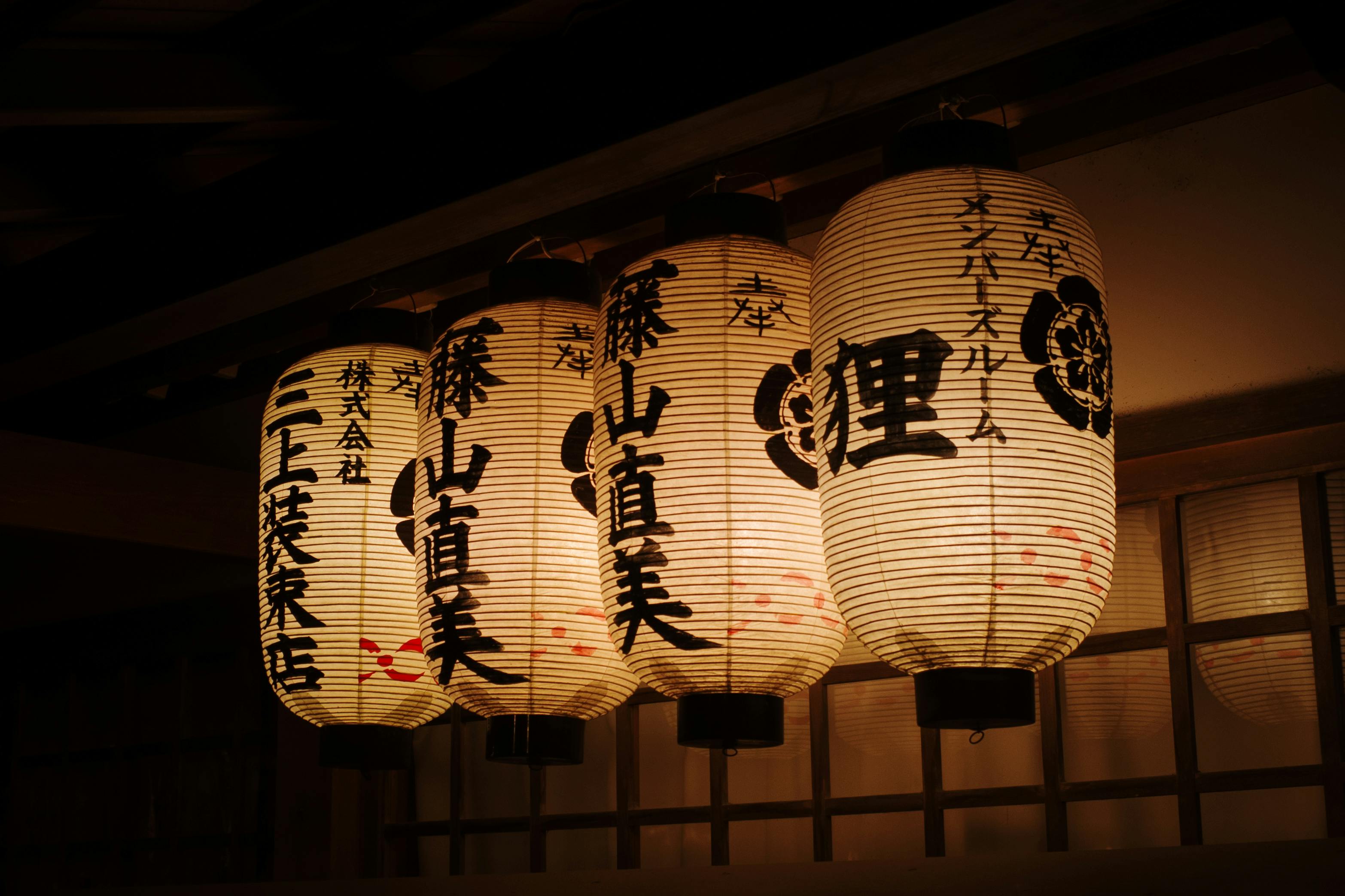Elegant Japanese lanterns glowing at night in Kyoto, capturing cultural ambiance.