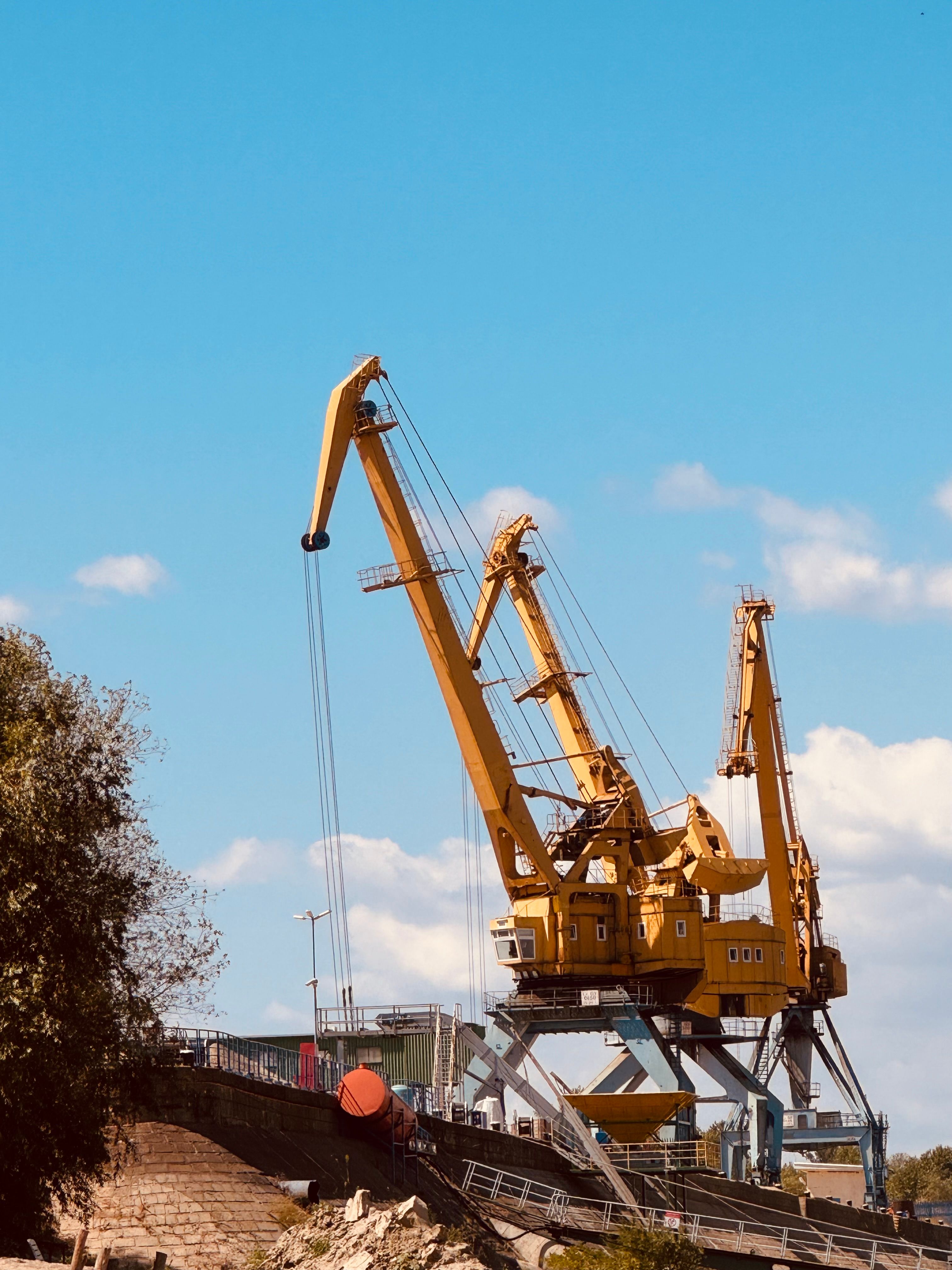Industrial Cranes at Work Under Blue Sky · Free Stock Photo