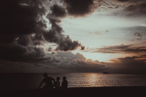Free Silhouette of people seated during a dramatic sunset in Bantayan, Philippines. Stock Photo
