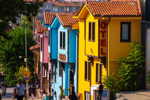 Bright and colorful houses along a lively street, showcasing vibrant architecture.