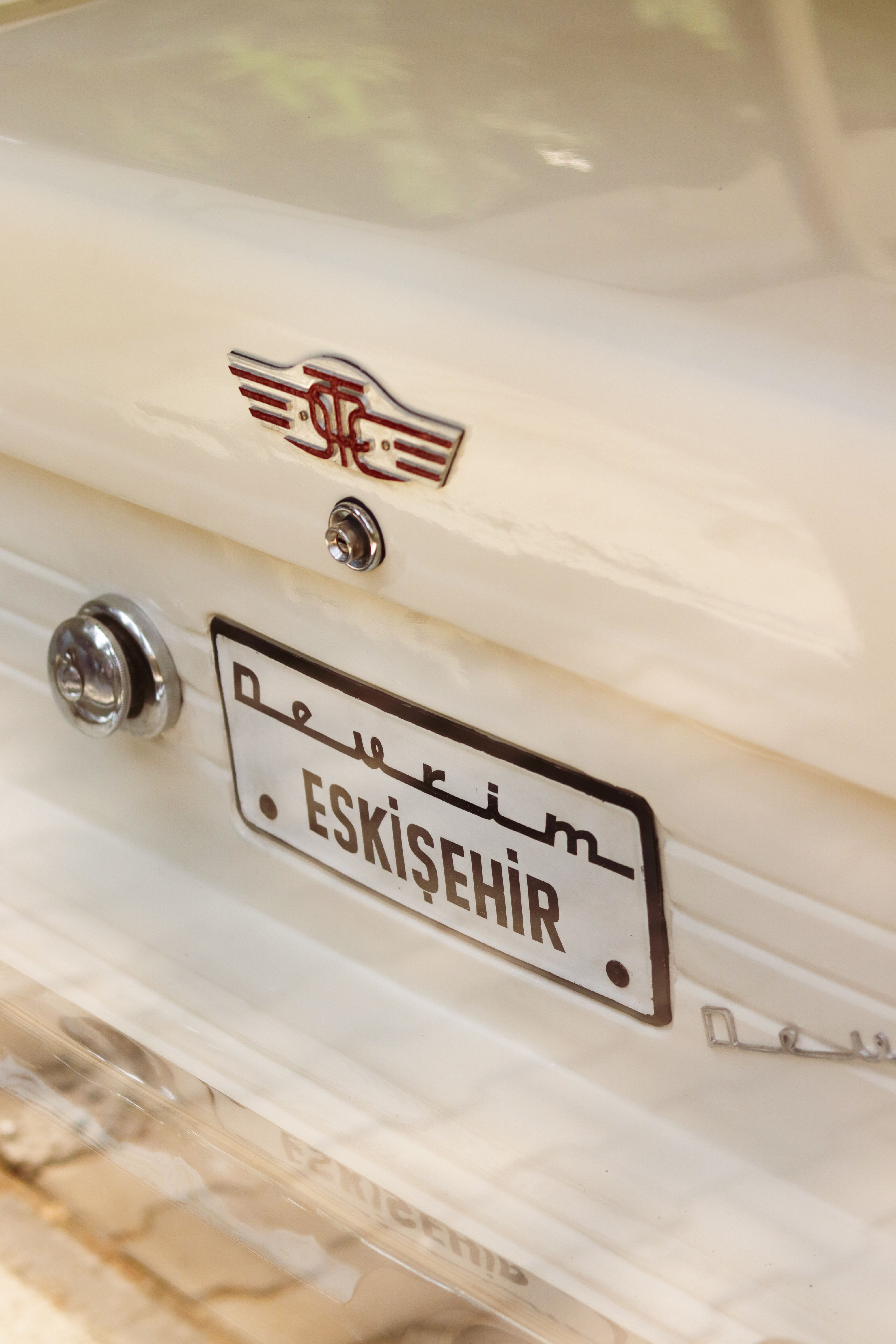 Close-up of a vintage Devrim car featuring an Eskişehir license plate, highlighting classic design.