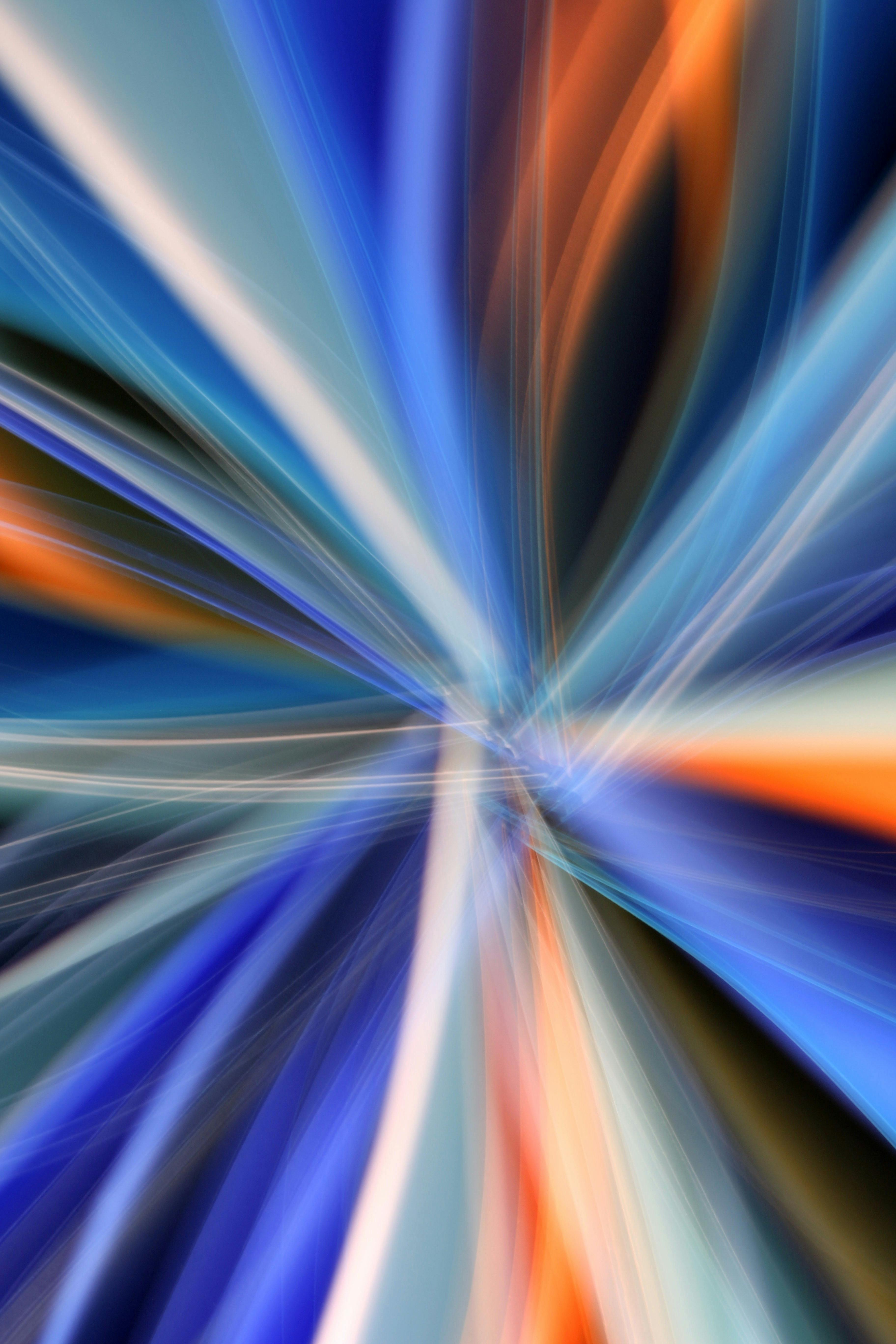 Dynamic abstract image with vivid blue and orange light streaks creating a sense of motion and energy.