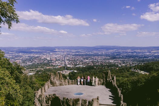 Scenic view of Kassel, Germany from a high vantage point with people enjoying the landscape.