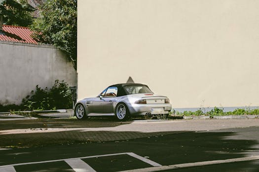 A vintage BMW convertible parked on a sunny street in Kassel, Germany.