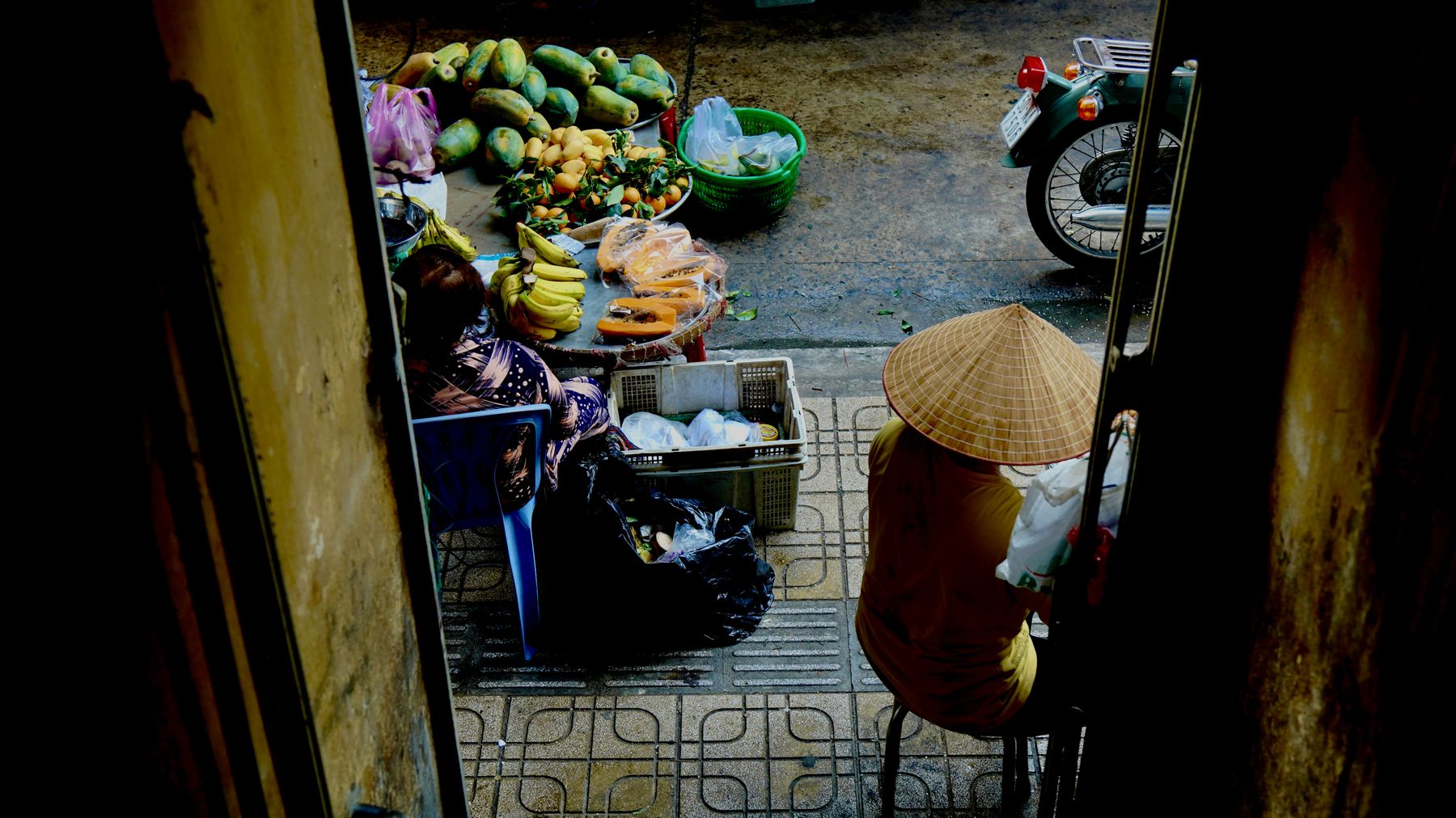 A vibrant view of a traditional outdoor market with fresh produce and two vendors.