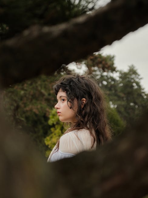Side view portrait of a person surrounded by lush greenery in Düsseldorf.