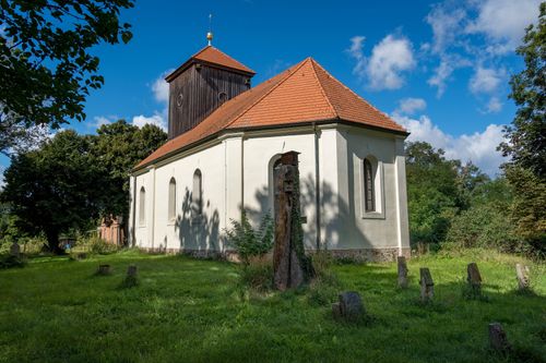 Free Charming rural church with baroque design, wooden tower, and cemetery in a scenic German setting. Stock Photo