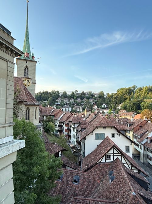 Free A picturesque view of Bern, Switzerland showcasing historic architecture under a clear summer sky. Stock Photo
