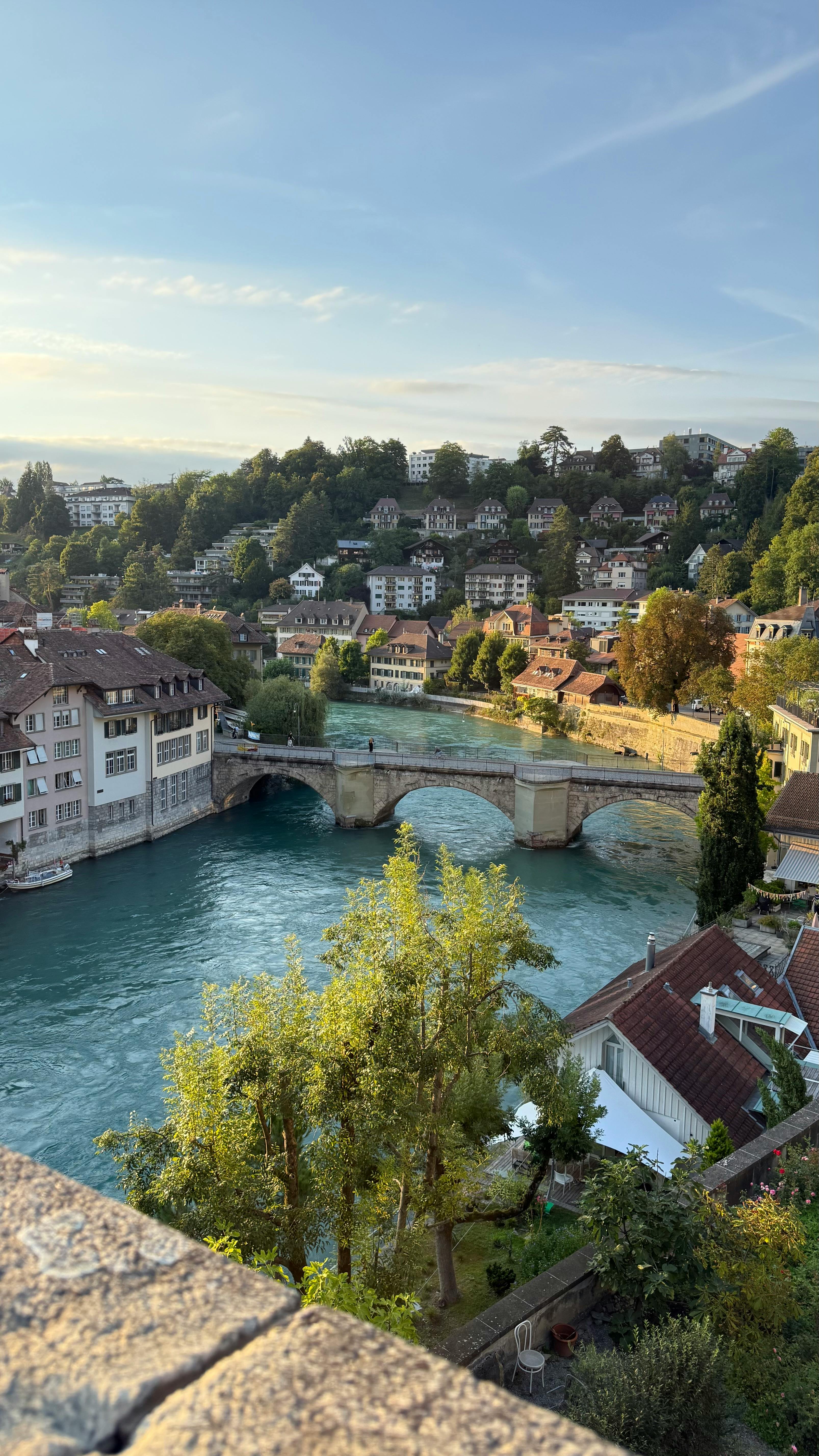 Scenic view of Bern, Switzerland, featuring historic bridge and river with charming architecture.