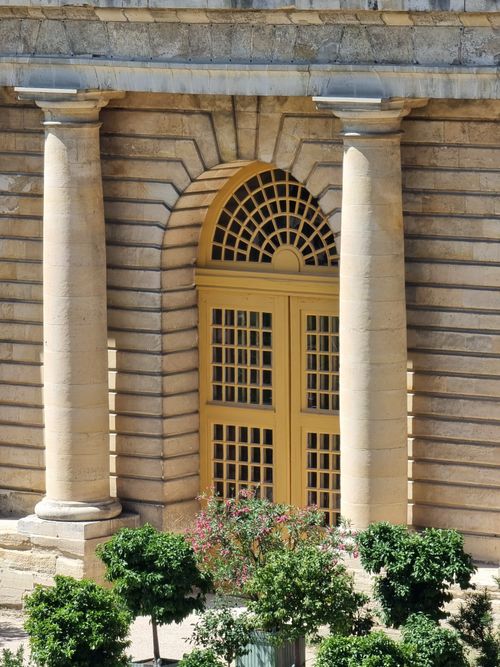 Free Historic stone archway and trees at the Palace of Versailles in France. Stock Photo