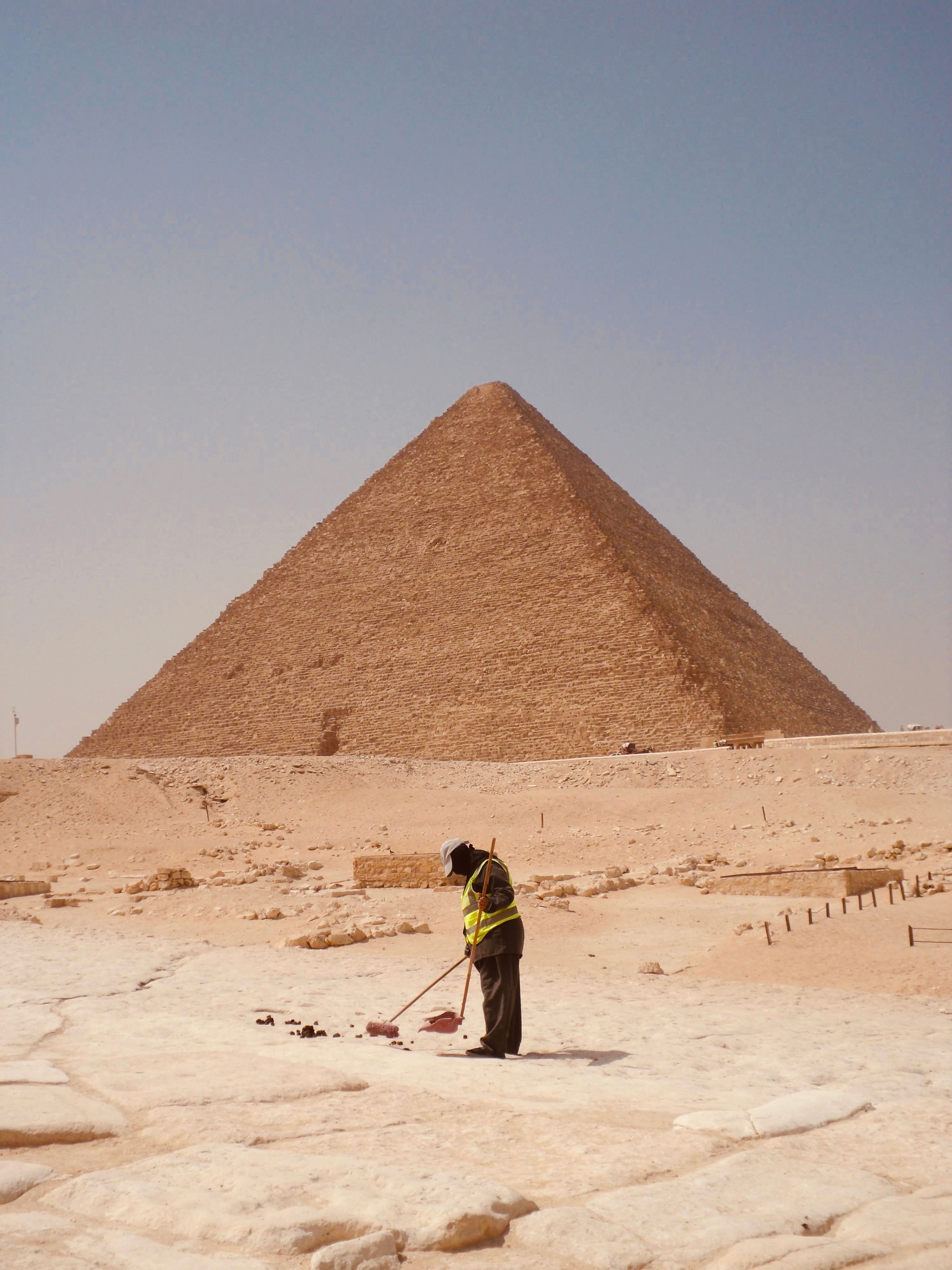 Great Pyramid of Giza with Worker in Foreground · Free Stock Photo