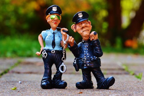 Free Police Man and Police Woman Plastic Toy on Fllow Stock Photo