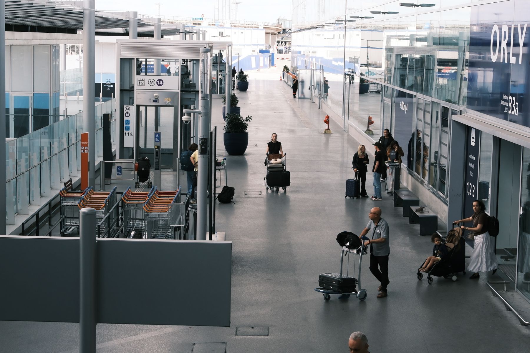Travelers moving through an airport terminal with luggage and suitcases
