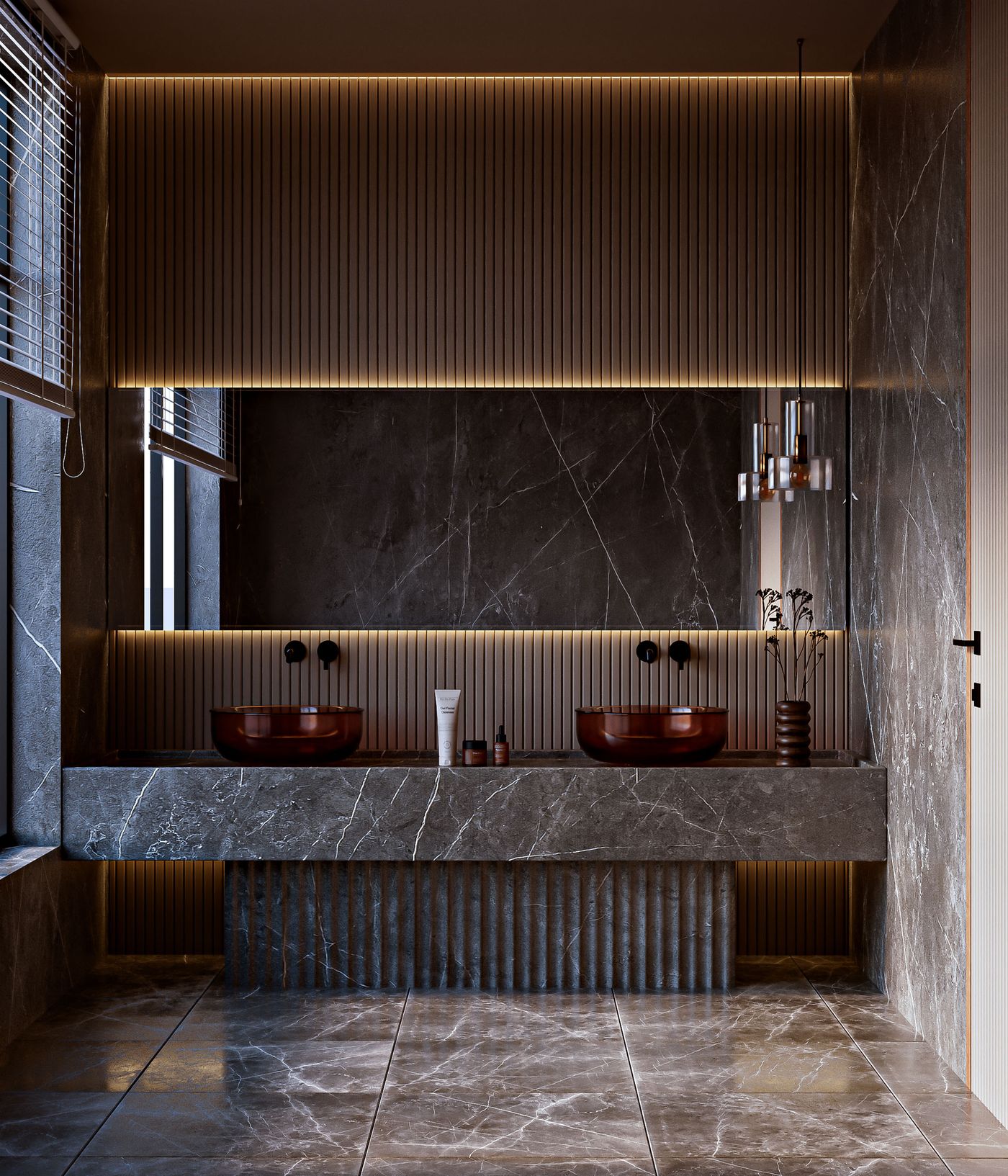 A marble bathroom vanity with brass fixtures and warm lighting