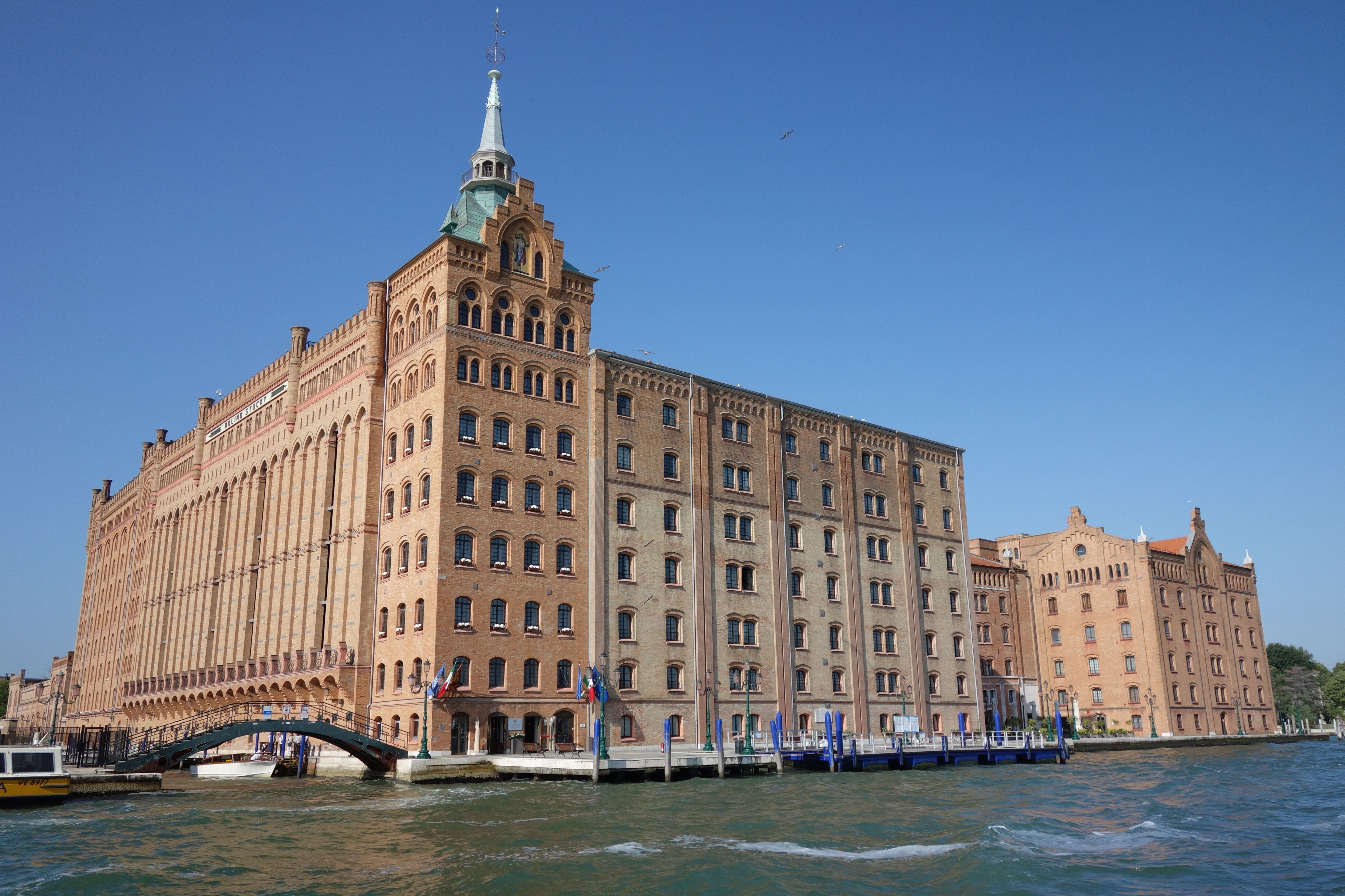 View of the iconic Molino Stucky building in Venice, Italy, with clear blue sky.