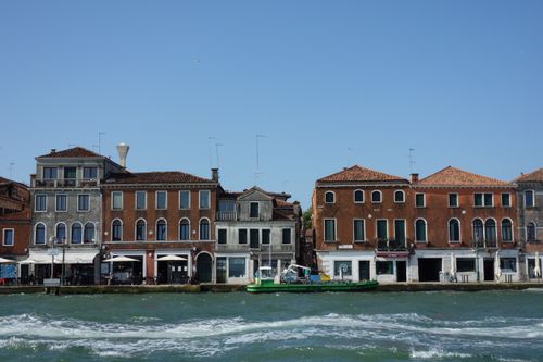 Free Classic Venetian buildings with a canal view under a clear blue sky. Stock Photo