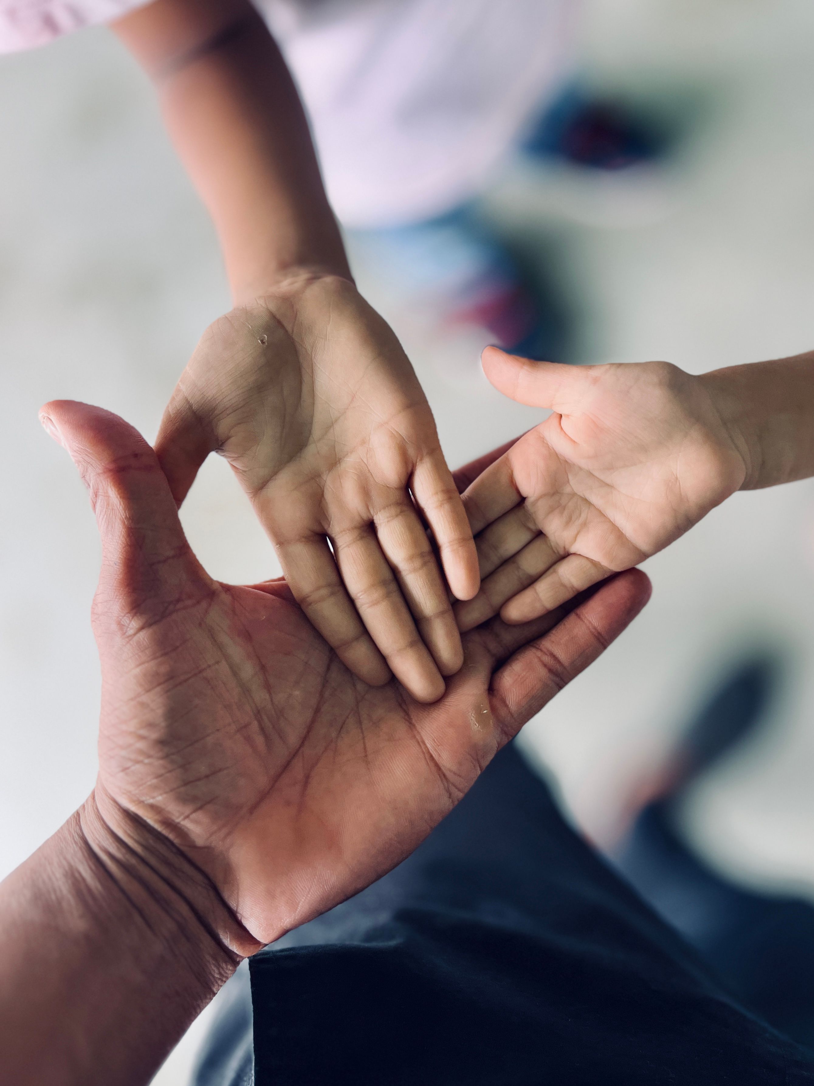 Close-Up of Three Hands Interacting · Free Stock Photo