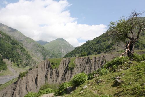 Free Stunning mountain view with a rugged, green terrain under a bright blue sky. Stock Photo