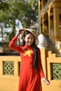 Vietnamese Woman in Red Ao Dai with Conical Hat