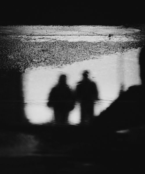Free Black and white abstract reflection of two figures in a puddle in Baguio, Philippines. Stock Photo