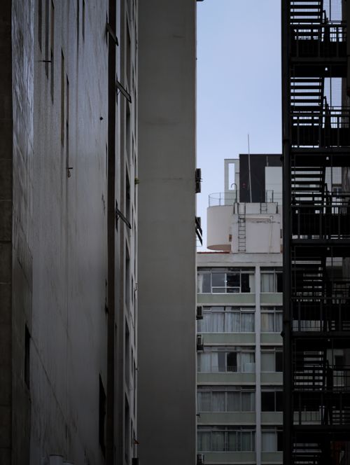 Free A minimalistic view between tall city buildings, showcasing urban architecture. Stock Photo