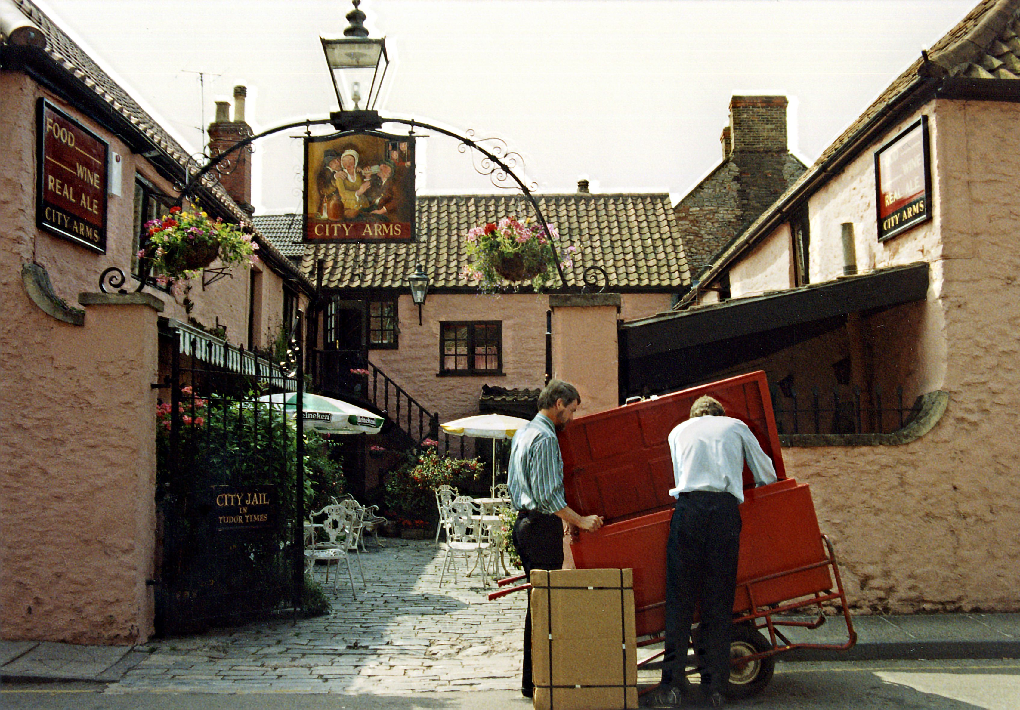 A thatched country pub with a beer garden and hanging flower baskets near Reading