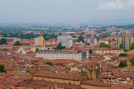 Aerial shot of Bologna's historic cityscape with earthy tones and classic architecture.