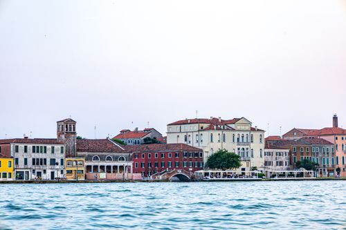 Free Charming Venetian buildings by the waterfront during the day, capturing classic architecture. Stock Photo