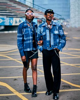 Trendy duo showcasing urban street style with denim jackets and accessories.