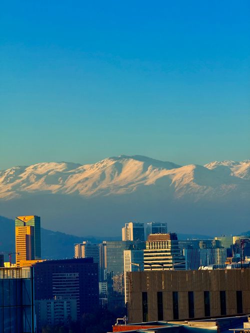 Free Captivating view of Santiago's skyline with snow-capped Andes mountains towering in the background. Stock Photo