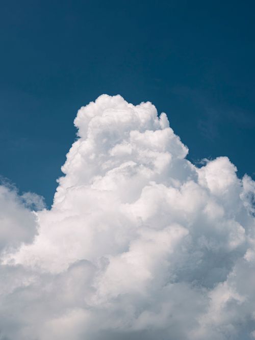 Free Majestic cumulus clouds tower against a clear blue sky, creating a stunning natural scene. Stock Photo