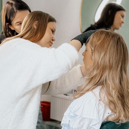 Makeup artist applying makeup to a woman's face
