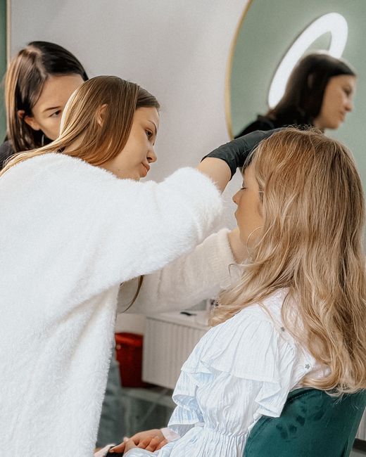 Makeup artist applying makeup to a woman's face