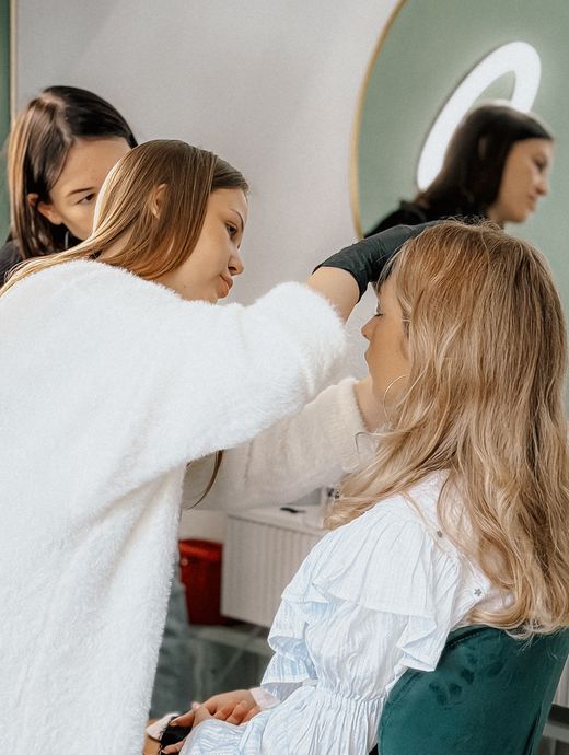 Makeup artist applying makeup to a woman's face