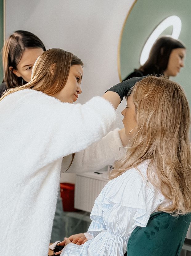 Makeup artist applying makeup to a woman's face