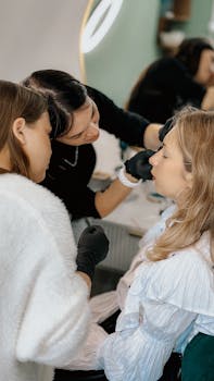 Women in a beauty studio engaged in a detailed makeup tutorial session.