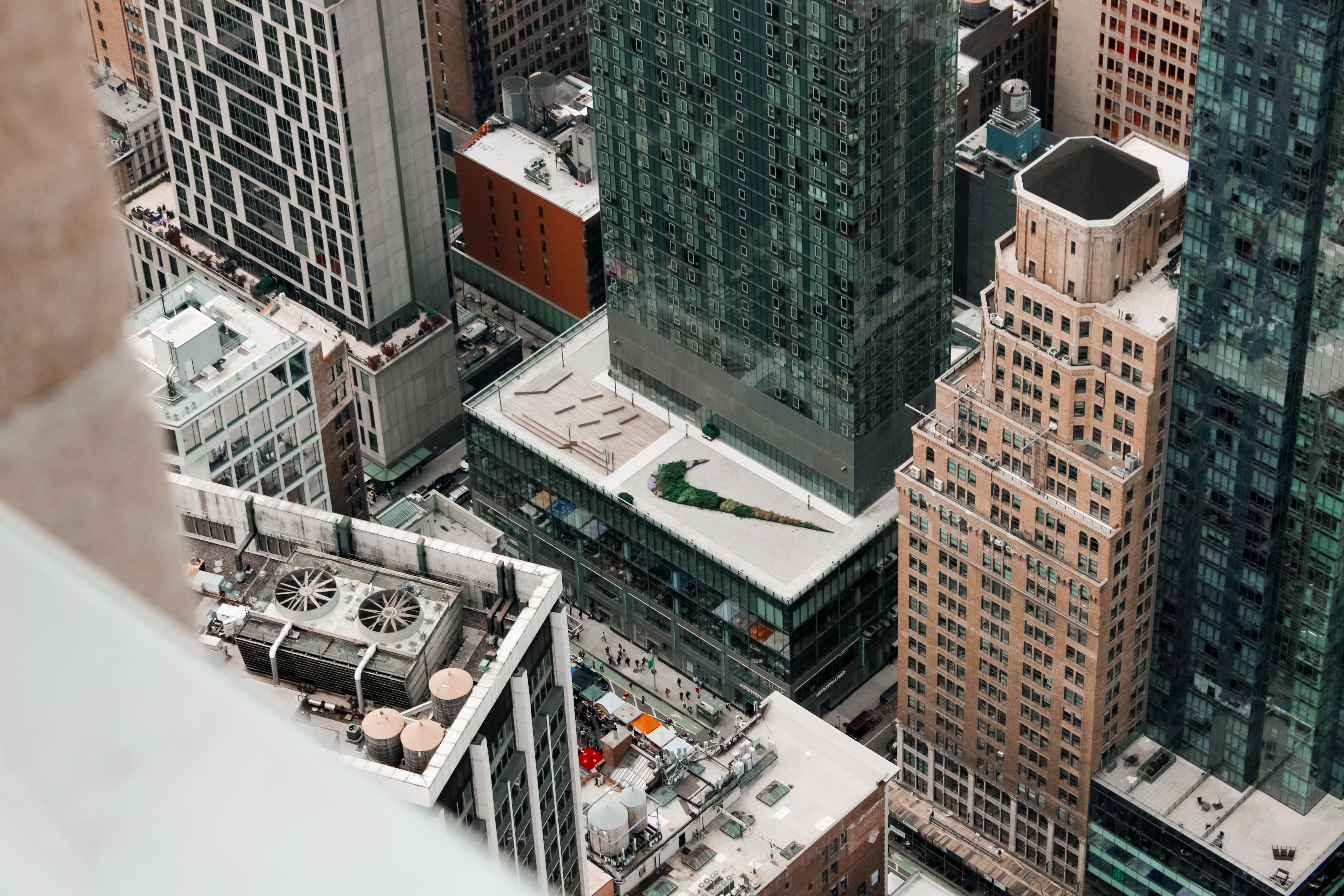 High-angle view of dense skyscrapers and rooftops in New York City, showcasing urban architecture.