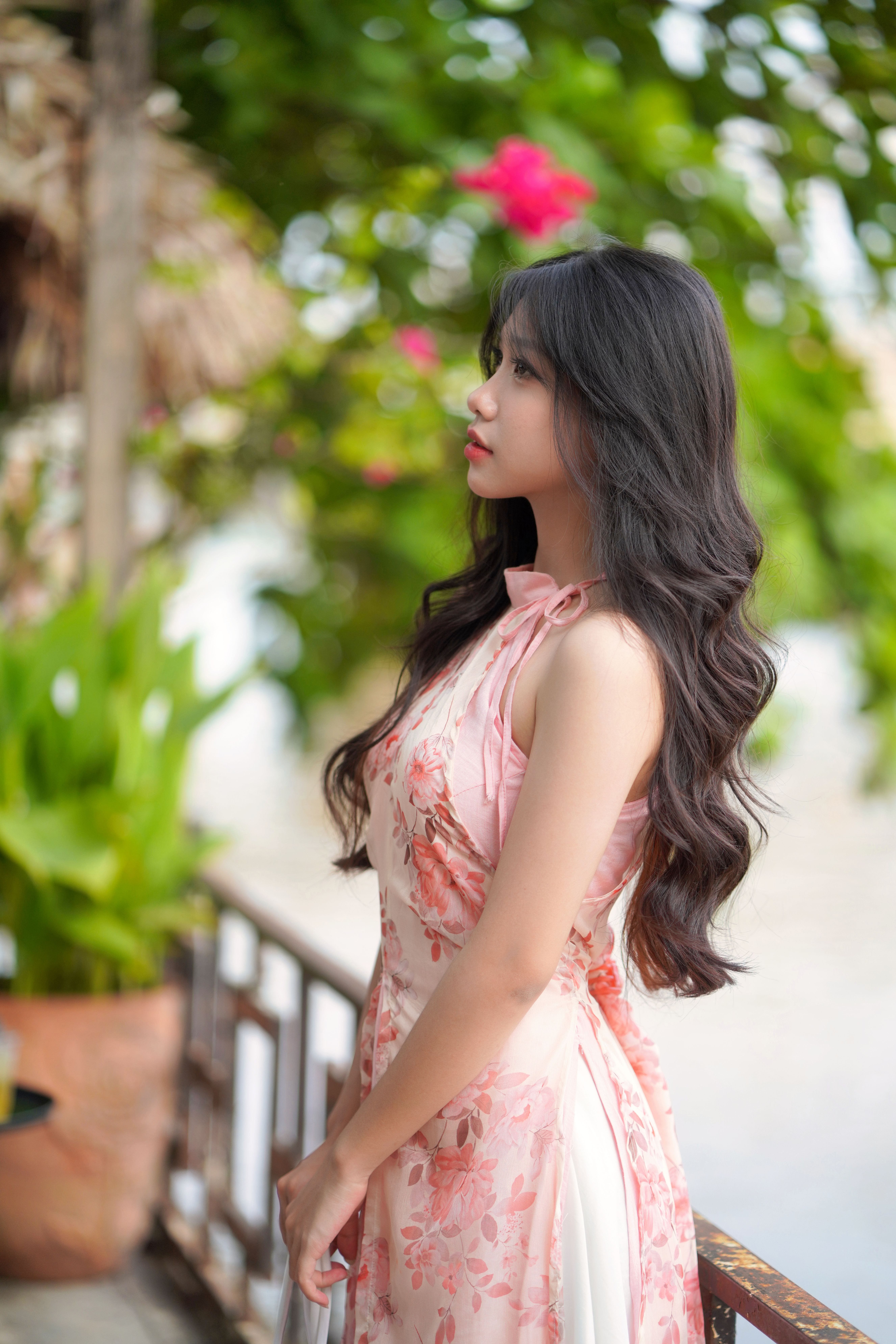 Elegant Woman in Floral Dress Posing Outdoors · Free Stock Photo