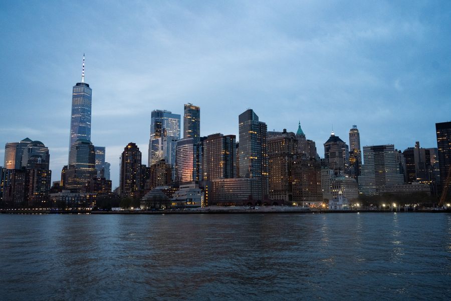 New York City skyline at dusk seen from across the water, the kind of view many American callers wake up to