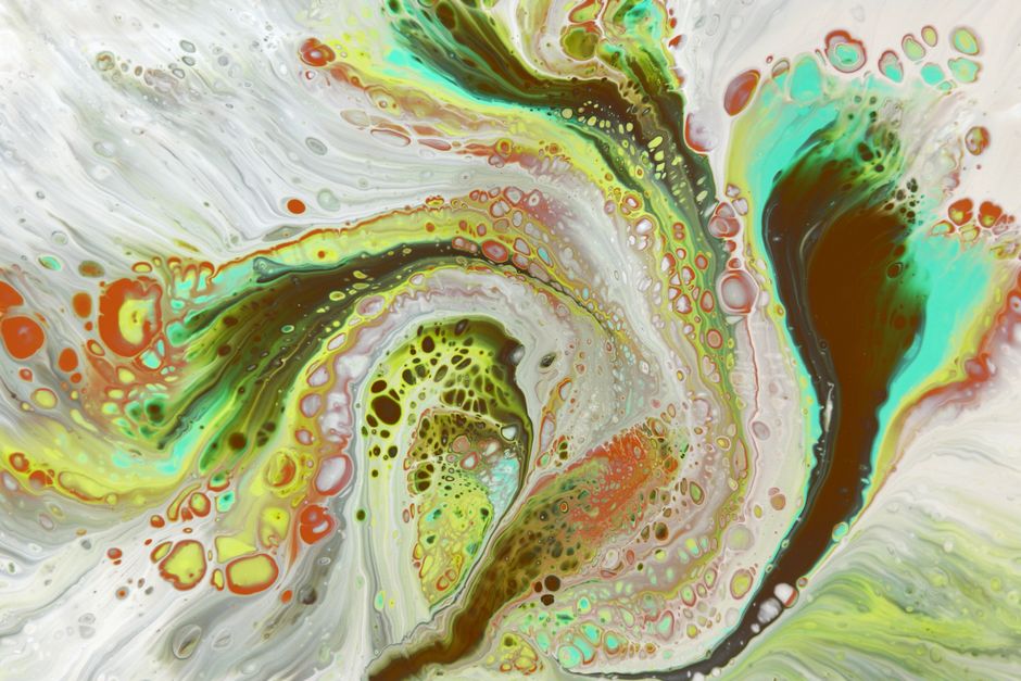 Dynamic abstract paint pattern featuring vivid swirls of color and texture.